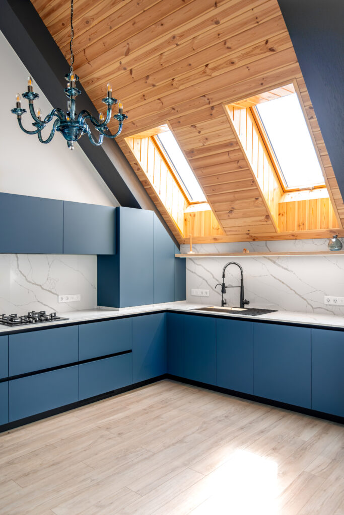 attic kitchen. wooden ceiling. modern blue fronts